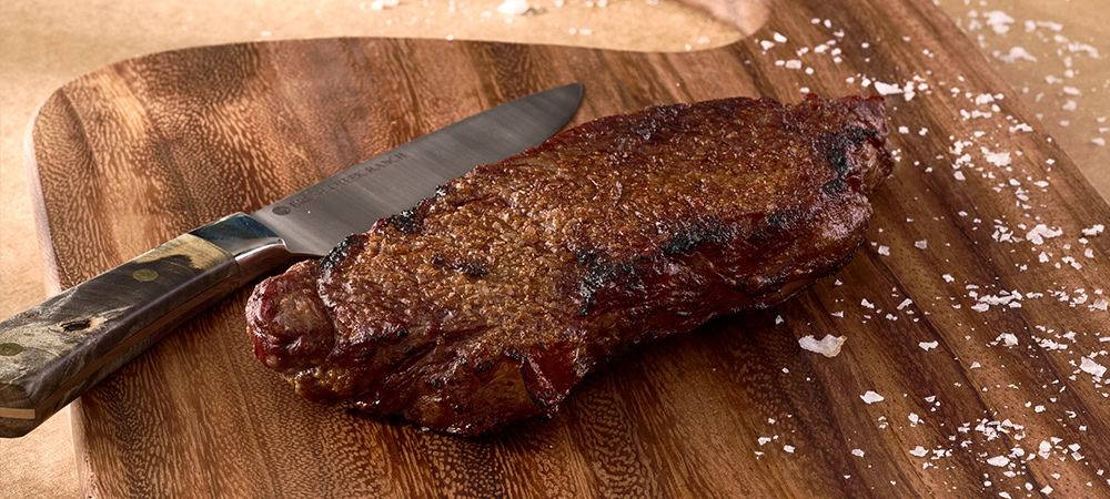 Vast-Creative_Hospitality-Branding-Agency_The-Summit-at-Brush-Creek-Ranch_Agenda-Off-Canvas_Waygu-Grilling A premium Wagyu beef